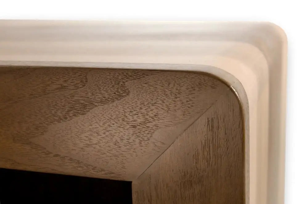 Custom Modern Dog Crate furniture with sleek rounded waterfall edge. close-up front corner face frame waterfall view shown in solid maple and walnut hardwood with sliding door and smooth horizontal steel bars in Champaign color finish