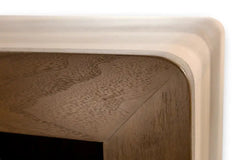 Custom Modern Dog Crate furniture with sleek rounded waterfall edge. close-up front corner face frame waterfall view shown in solid maple and walnut hardwood with sliding door and smooth horizontal steel bars in Champaign color finish